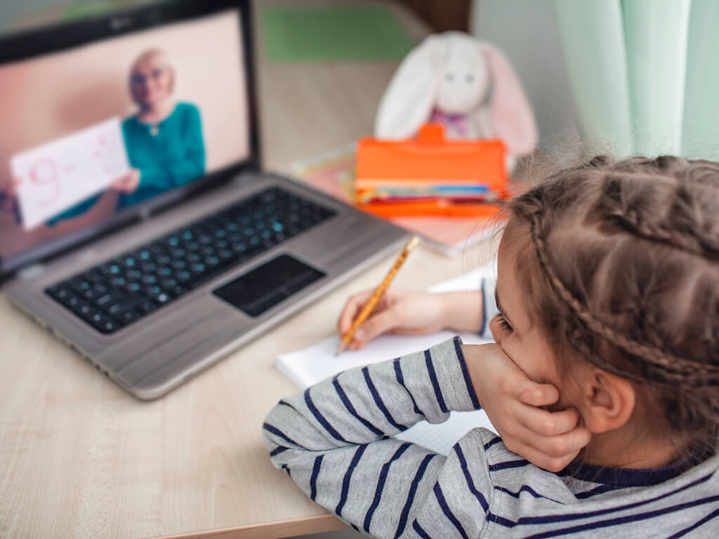 Online K–5 tutor working one-on-one with a young student on writing